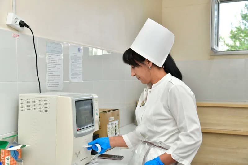 Female healthcare worker operating laboratory equipment