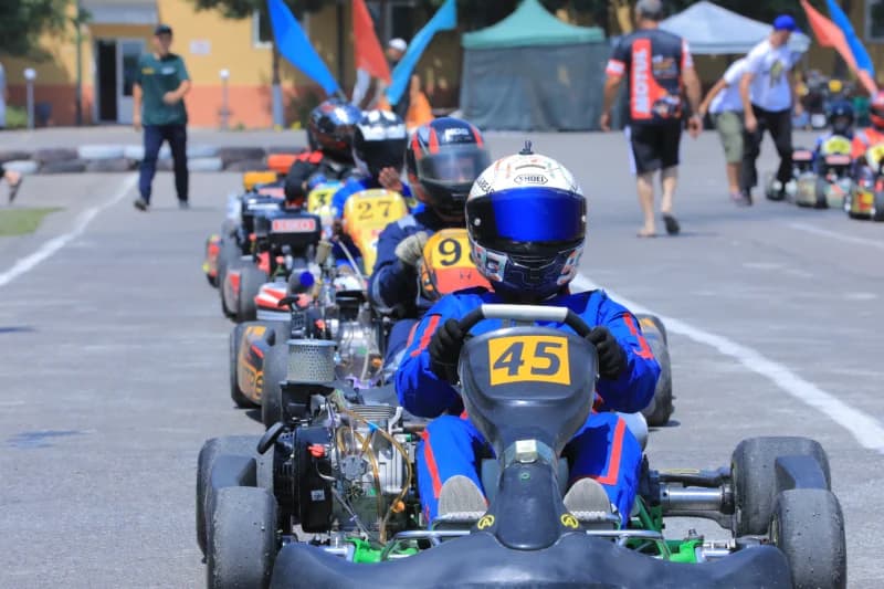 Drivers racing go-karts on track