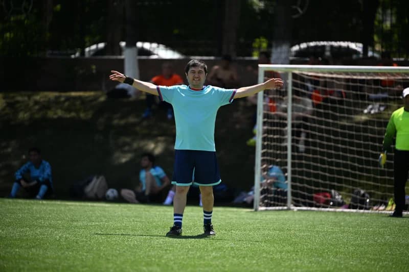 Erkak futbol maydonida golni nishonlamoqda