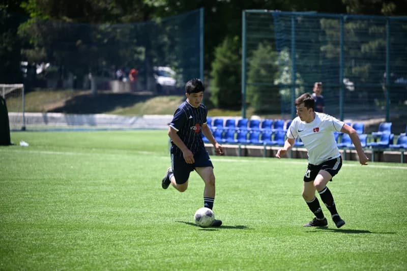 Young athletes playing football match