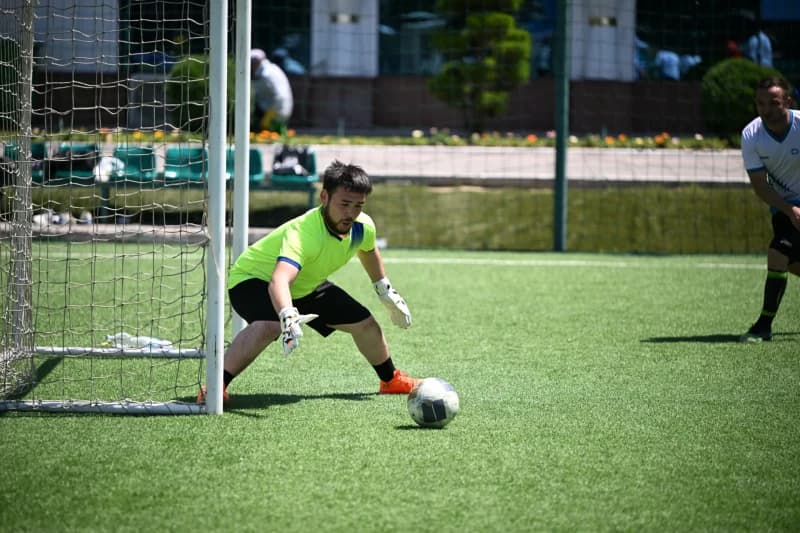 Goalkeeper blocking ball on field