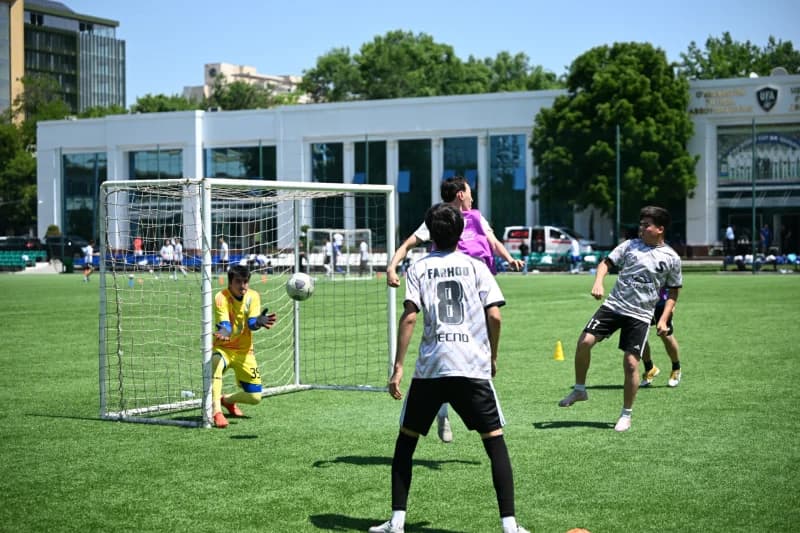Young athletes playing football match