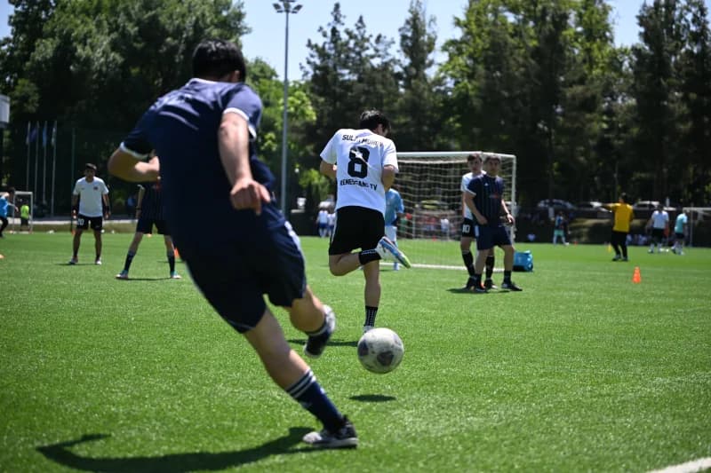 Young athletes playing football match