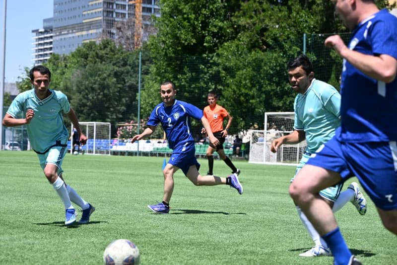 Men playing football on field