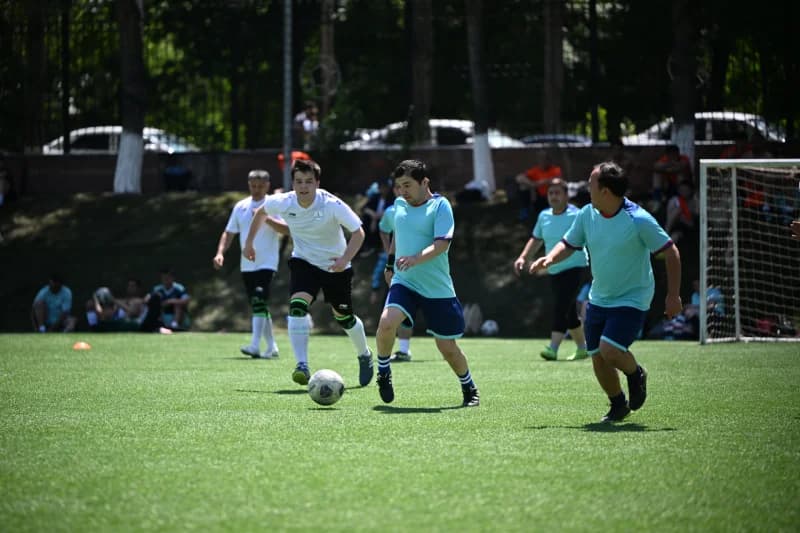 Men playing football on field