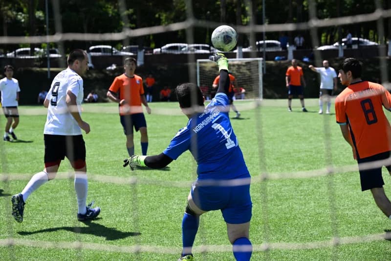 Goalkeeper jumping to catch ball