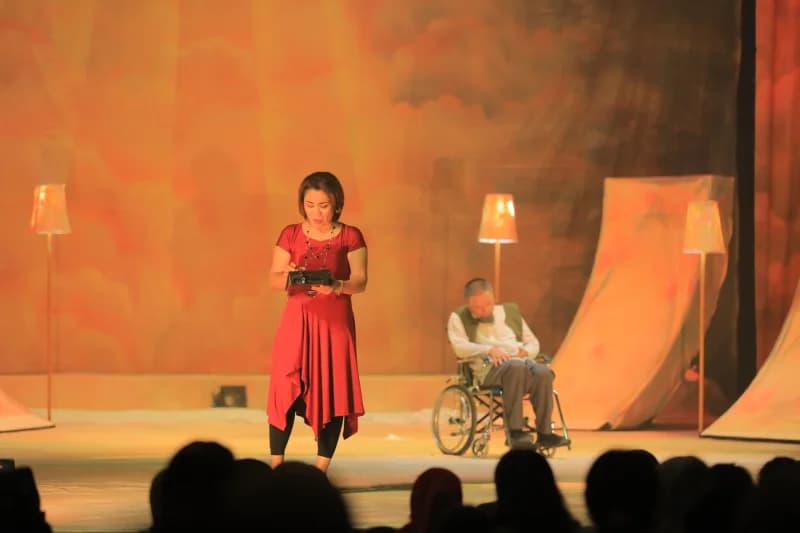 Woman performing on stage with man