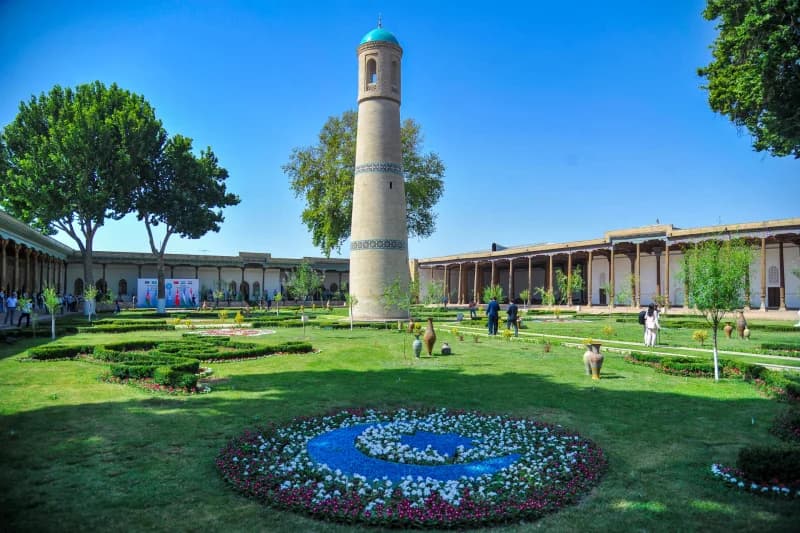 Historic courtyard with minaret and garden
