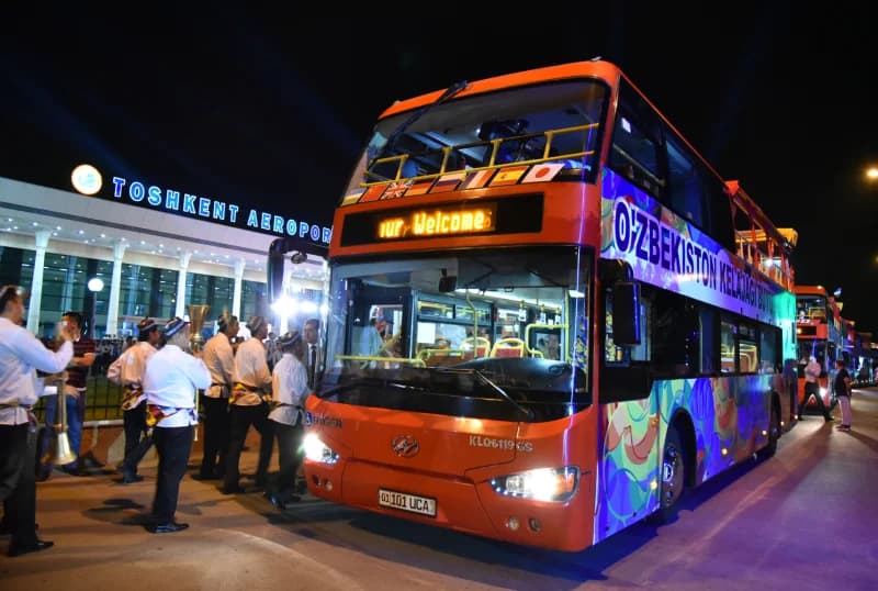Tour bus parked outside a building at night
