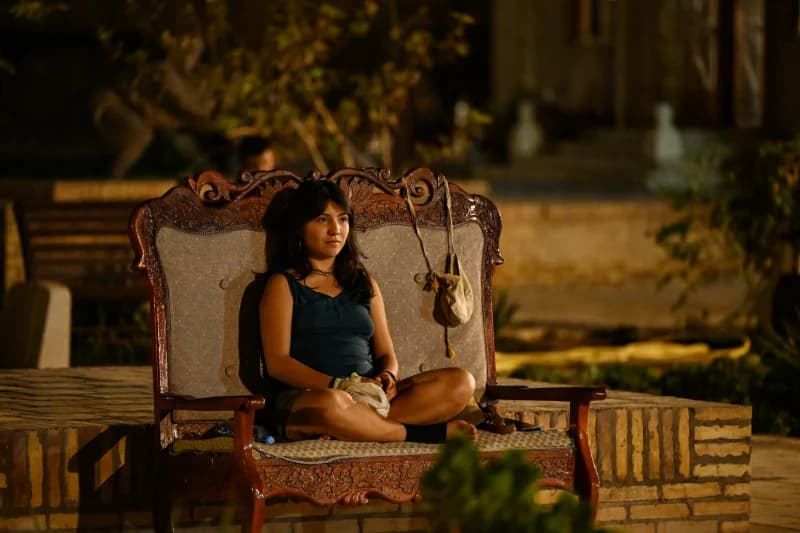 Person sitting outdoors at night