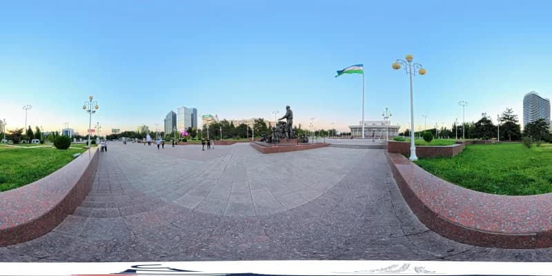Public square with monument and flag in city