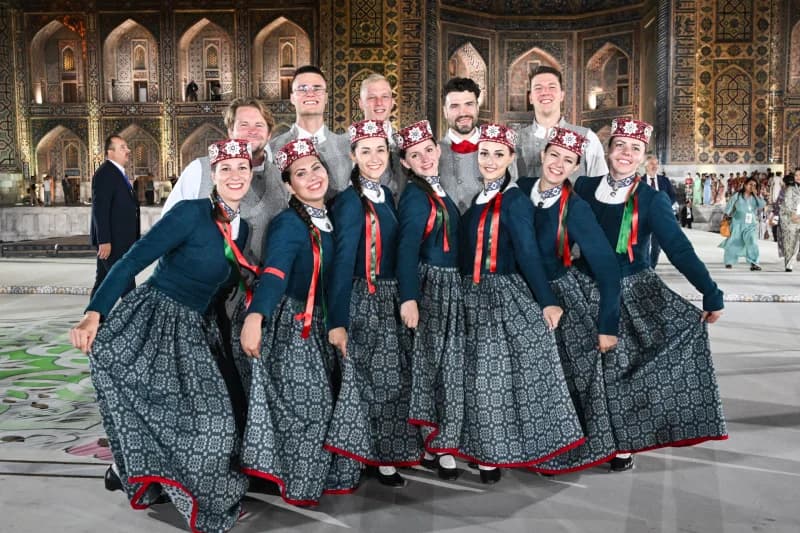Group in traditional costumes posing together in Samarkand