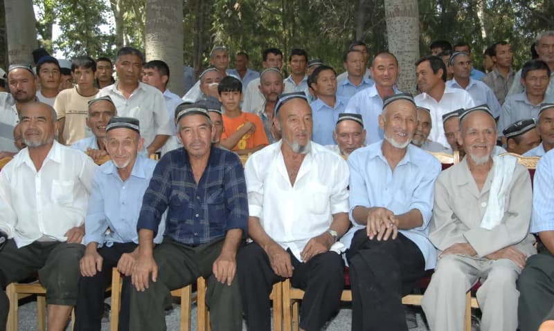 Group of men sitting outdoors
