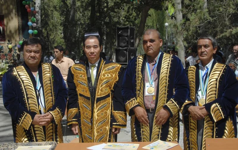 Group photo of men in traditional robes outdoors