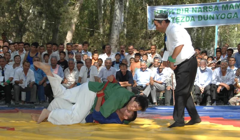 Men competing in a traditional wrestling match