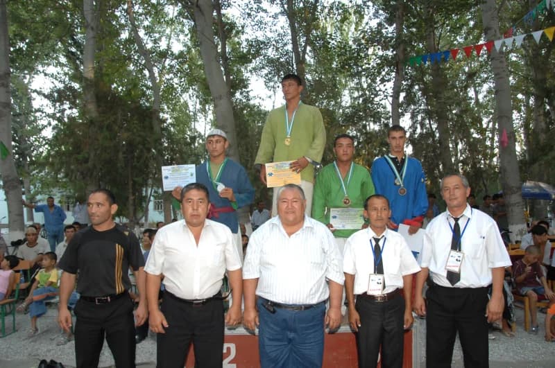 Athletes standing on podium during sports award ceremony outdoors