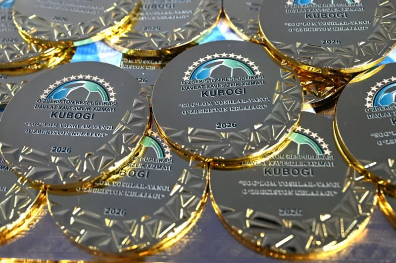 Close-up of golden medals with visible text