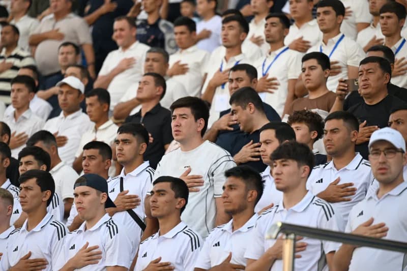 People stand in stadium seating