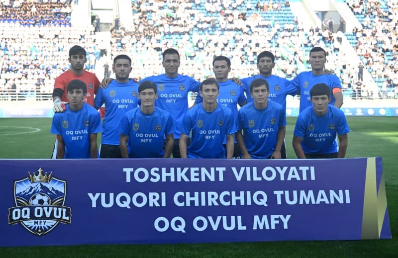Football team standing together in stadium