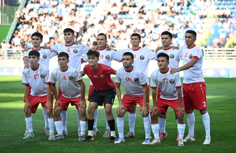 Group of football players standing on stadium turf