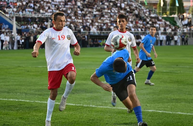 Football match action on a grassy field
