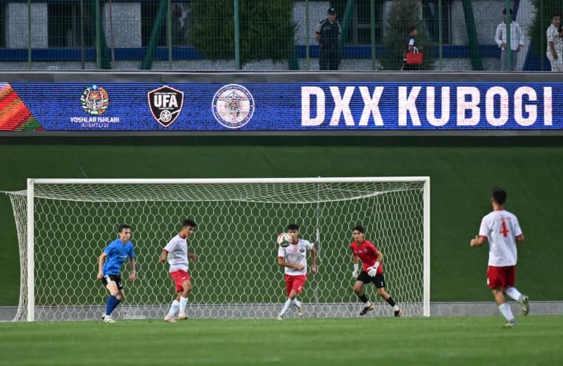 Players on a football field during a match