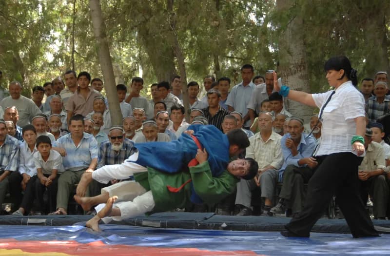 Wrestlers competing in a traditional match outdoors