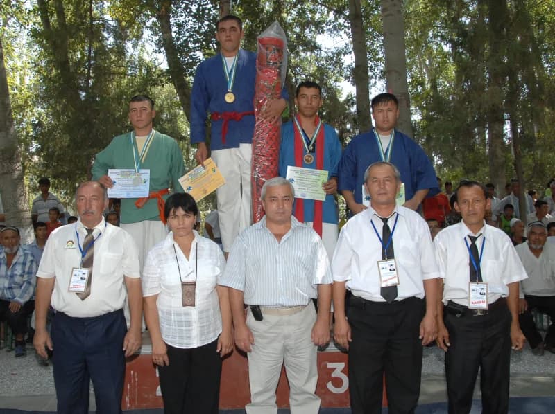 Athletes and officials posing at a sports competition ceremony