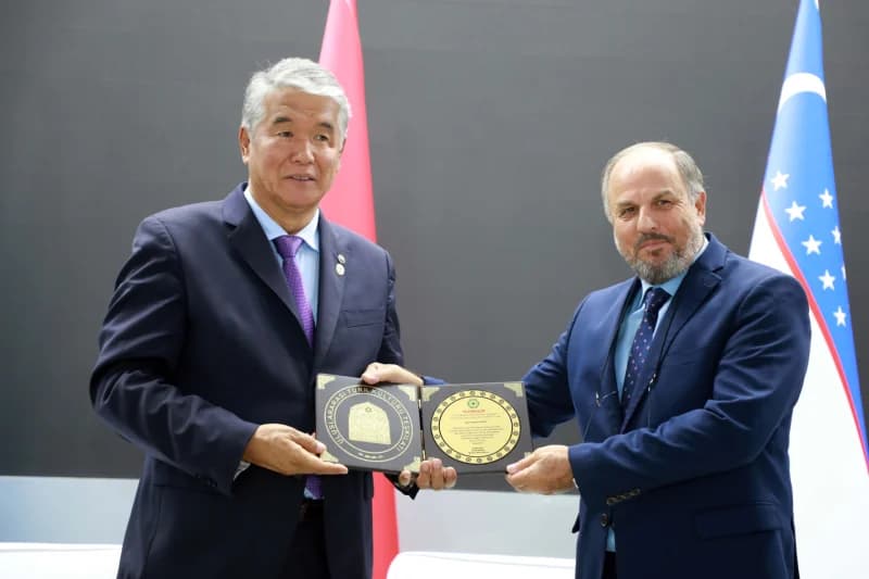Two men holding a plaque