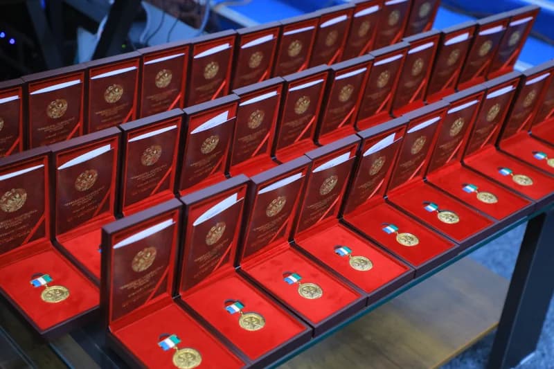 Rows of medals in red cases arranged on a table