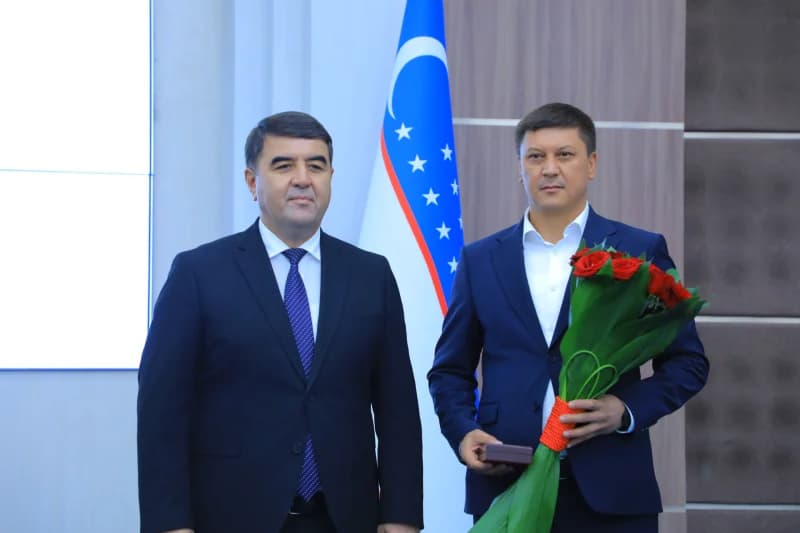 Two men standing together indoors