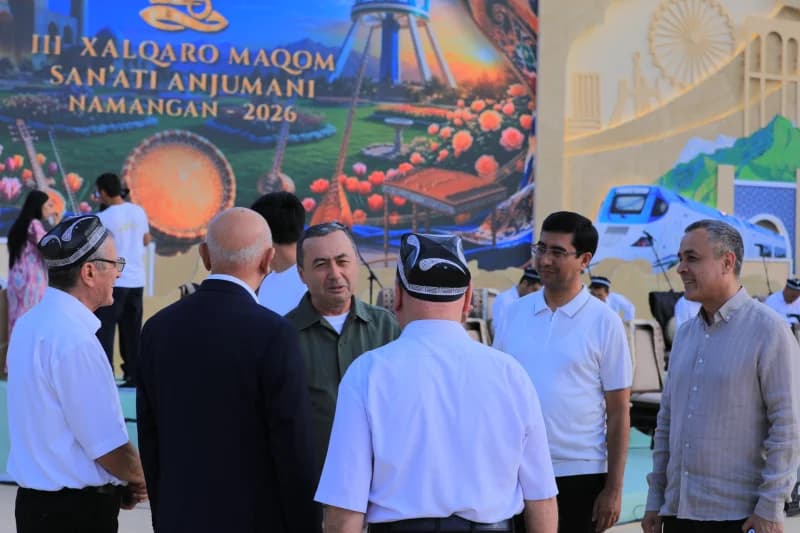 People gathered in front of a decorated banner
