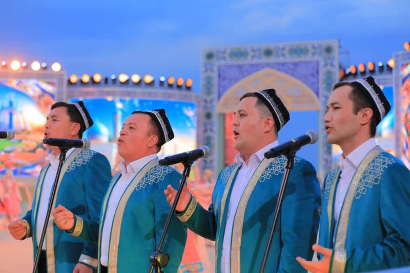 Men performing on stage in traditional attire