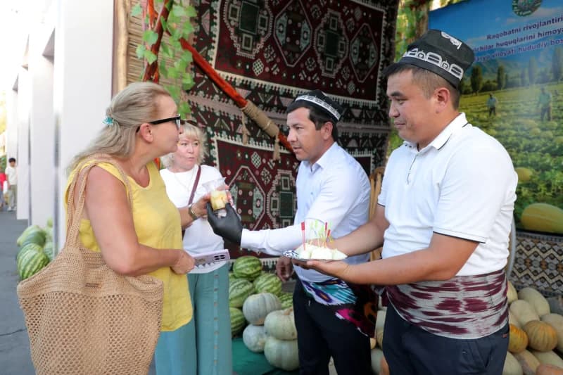 People interacting at a food and culture display