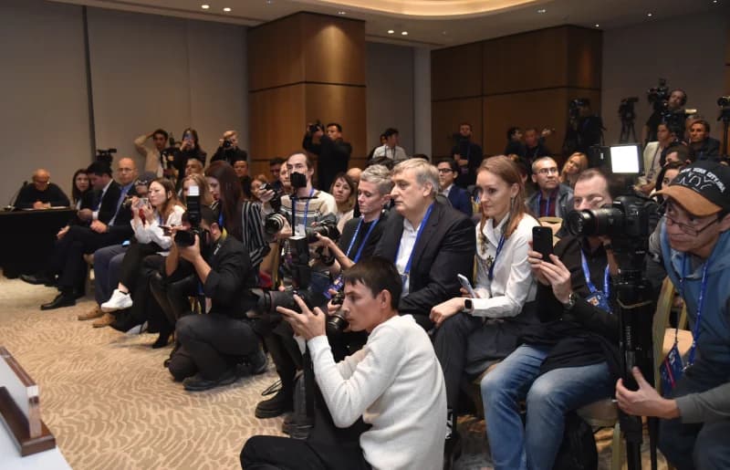 People taking photos and videos with cameras and phones