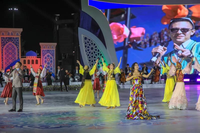 People in traditional clothing perform on stage