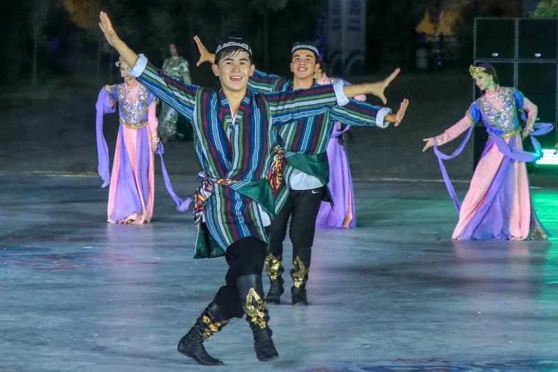 Performers in traditional attire dancing outdoors