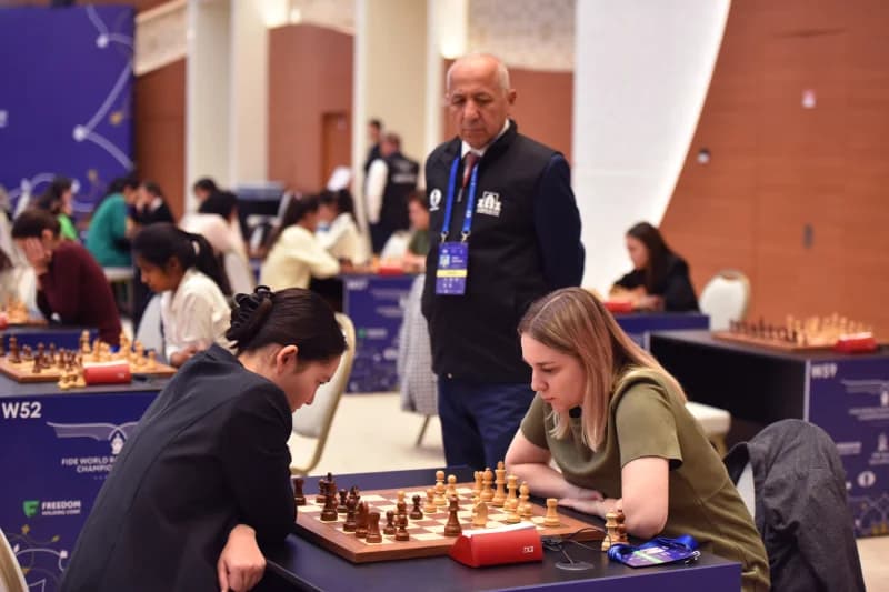 People playing chess at a competition table
