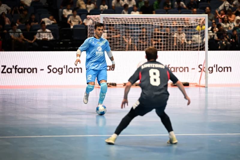 Futsal players competing during an indoor match