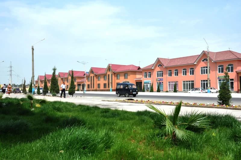 Street view of row houses and parked vehicles