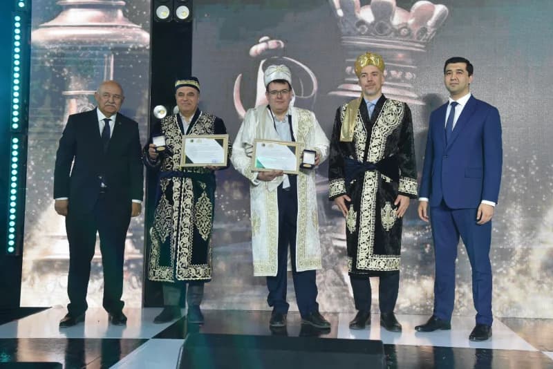 Group photo of men receiving certificates and awards on stage