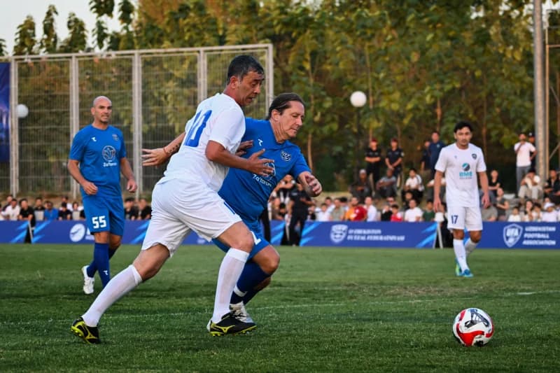 Players competing in a football match on an outdoor field