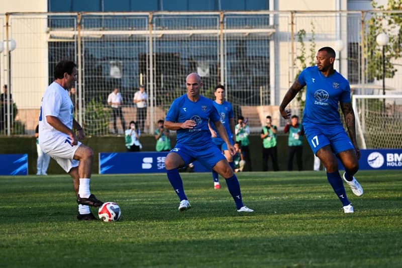 Men playing football on grass pitch