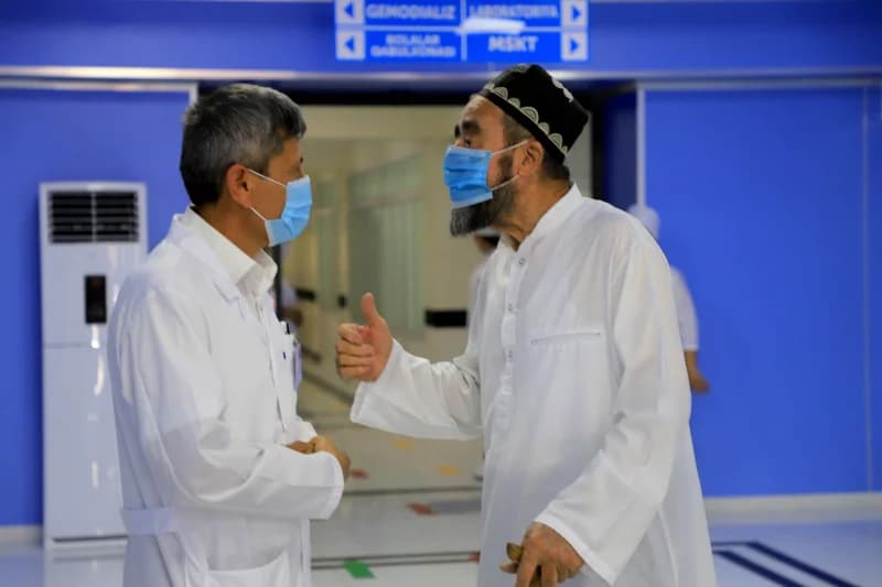 People talking in a medical facility wearing face masks