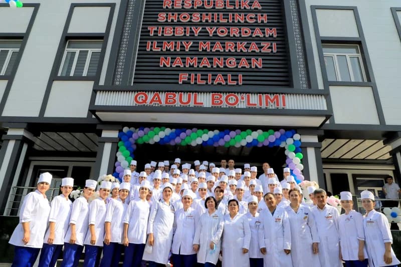 Medical staff gathered in front of a healthcare building
