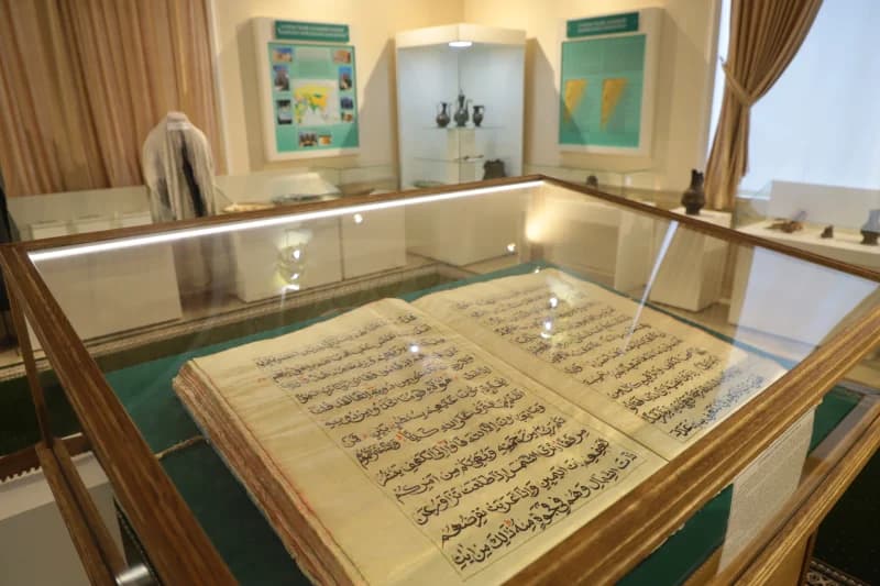 Historical manuscript on display in museum exhibition case
