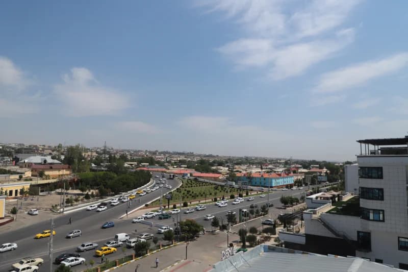 High angle panoramic view of urban traffic on city streets under a blue sky