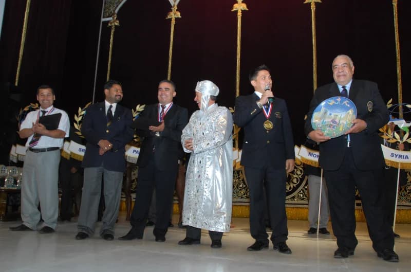 Group of men standing on stage during an event