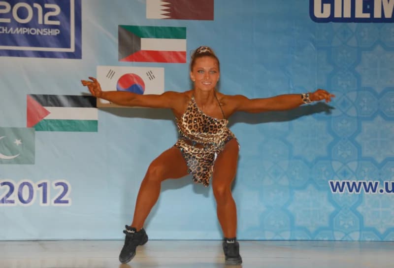 Athletic woman posing on stage during a sports competition