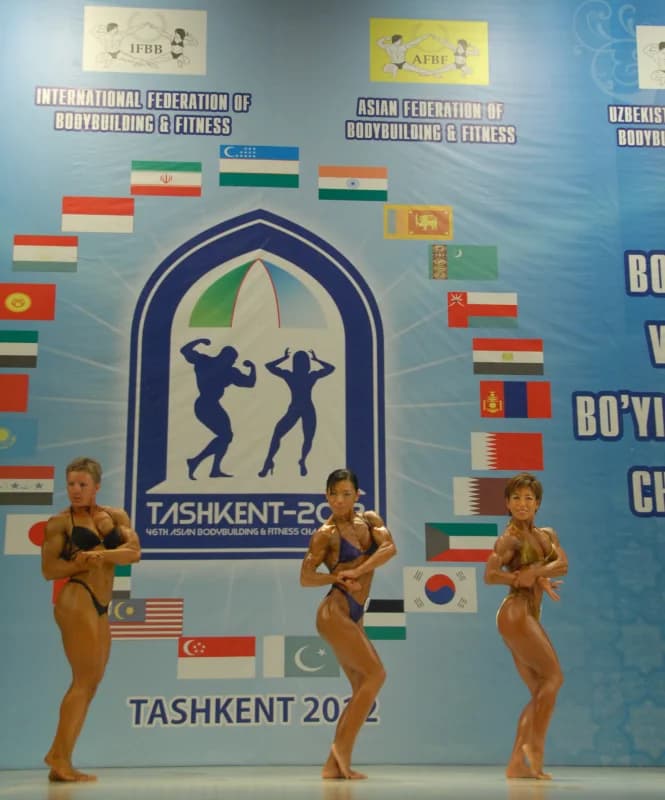 Female bodybuilders posing on stage at a competition